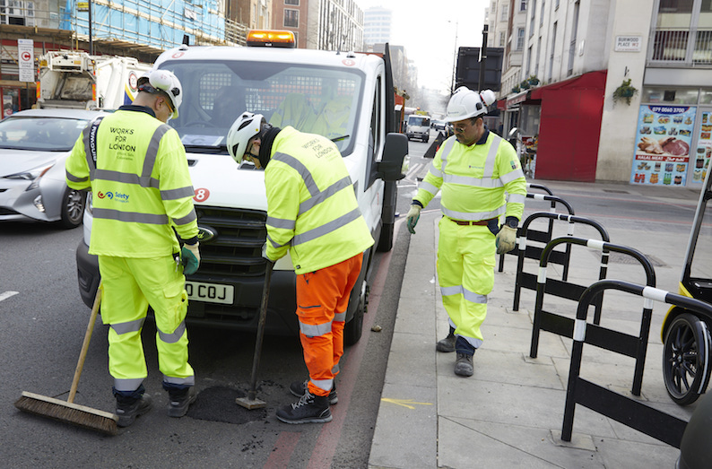 * spring clean_0564 find and fix gang repairing potholes.jpg